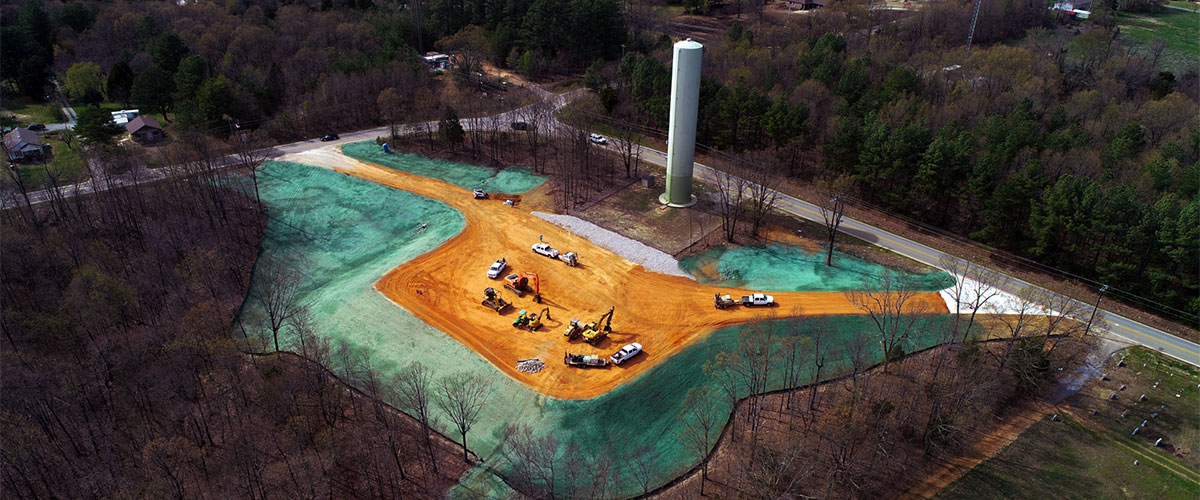 Photo of dirt and hydroseeding around a water tower